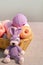 Lilac knitted hare toy with a basket of skeins of thread, home needlework