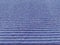 Lilac or purple striped ribbed fabric. Close-up shot of a dish washing sponge or microfiber cloth. Soft focus