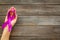 Lilac ribbon in hands is symbol of Alzheimers disease on dark wooden background top view copy space