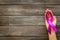 Lilac ribbon in hands is symbol of Alzheimers disease on dark wooden background top view copy space