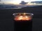 Lilac and Violet Candle Burning with Two Flames during Sunset at Beach in Kekaha on Kauai Island, Hawaii.