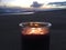 Lilac and Violet Candle Burning with Two Flames during Sunset at Beach in Kekaha on Kauai Island, Hawaii.