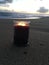 Lilac and Violet Candle Burning with Two Flames during Sunset at Beach in Kekaha on Kauai Island, Hawaii.