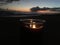 Lilac and Violet Candle Burning with Two Flames during Sunset at Beach in Kekaha on Kauai Island, Hawaii.