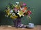 Lilies daisies ageratum and other flowers in a jug