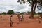 LILONGWE, MALAWI, AFRICA - APRIL 1, 2018: Bright road scene, african man is walking and african women with children are selling