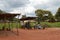 LILONGWE, MALAWI, AFRICA - APRIL 1, 2018: Bright road scene, six african men are sitting under wooden construction along the road