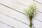 Lily of the valley bouquet of white flowers tied with string on a white background barn boards