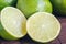 Lime citrus fresh fruits on wooden table. Close up shot of limes. Focus on the central part of sliced lime. Lime slice, piece, hal