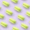 Lime dessert cake macaron or macaroon on trendy pastel lilac background top view