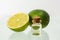 Lime essential oil and whole lime. Aromatherapy. Isolated