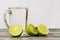 Lime glass and a glass of drink on a wooden table