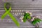 Lime green ribbon. Mental health awareness month concept mental health letters on old aged wooden background with