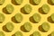 Lime halves on a yellow background close-up