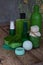 Lime mint composition of beauty threatment products in green colors on brown wooden background: shampoo, soap, bath salt, towel, o