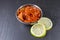 Lime pickle with lime slices on slate background