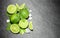 Limes and mint on stone background. Top view with copy space