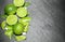 Limes and mint on stone background. Top view with copy space
