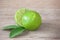 The limes, slice and leaves on wooden board