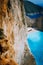 Limestone chalk huge cliff rocks and Navagio beach with abandoned Shipwreck in the distance. Azure blue colored sea