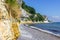 Limestone cliffs above a shore of flints