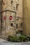 Limestone corner house with two traffic signs for wrong direction and pot plants, in Valetta, Malta