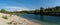 Limestone mountains and calm blue groundwater lake in an old quarry