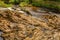 Limestone rocks with a calm water flow in the Clifden waterfalls on the Owenglin or Owenglen river