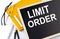 LIMIT ORDER text on the blackboard with notepad , pen, pencil