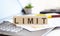 LIMIT Wooden cubes with letters on a laptop keyboard