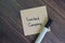 Limited Company write on sticky notes isolated on Wooden Table