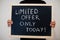 Limited offer only today! written on blackboard. Black friday concept. Boy hold board
