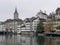 Limmat River Bank with historical buildings, houses and St. Peter church