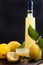 Limoncello in a bottle and a small shot with liquor. The traditional alcoholic beverage of Italy, from citrus. Fresh fruits and