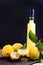 Limoncello in a bottle and a small shot with liquor. The traditional alcoholic beverage of Italy, from citrus. Fresh fruits and