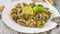 Limpets molluscs with lime on white plate