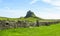 Lindisfarne Castle panoramic view, rock fence and wooden gate, Holy Island, Northumberland