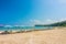 Line of beach umbrellas and sunbathe seats on Phuket sand beach