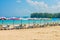 Line of beach umbrellas and sunbathe seats on Phuket sand beach