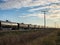 Line of Black Tank Train Cars Under Blue Sky