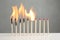 Line of burning and whole matches on table
