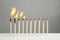 Line of burning and whole matches on table