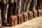 Line of Businessmen with Briefcases, Symbolizing Social Conformity