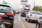 Line of cars and truck standing on road in rush hour