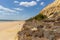 Line of cliffs and vegetation and sea and beach