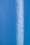 Line clouds trace of flied jet on a blue sky background.