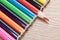 Line of colorful pencil crayons on wood