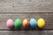 Line of easter eggs on wooden background.