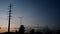 A line of electric tower, adjoin with street lamp on sunset