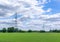 Line of Electricity Pylons in Green Field